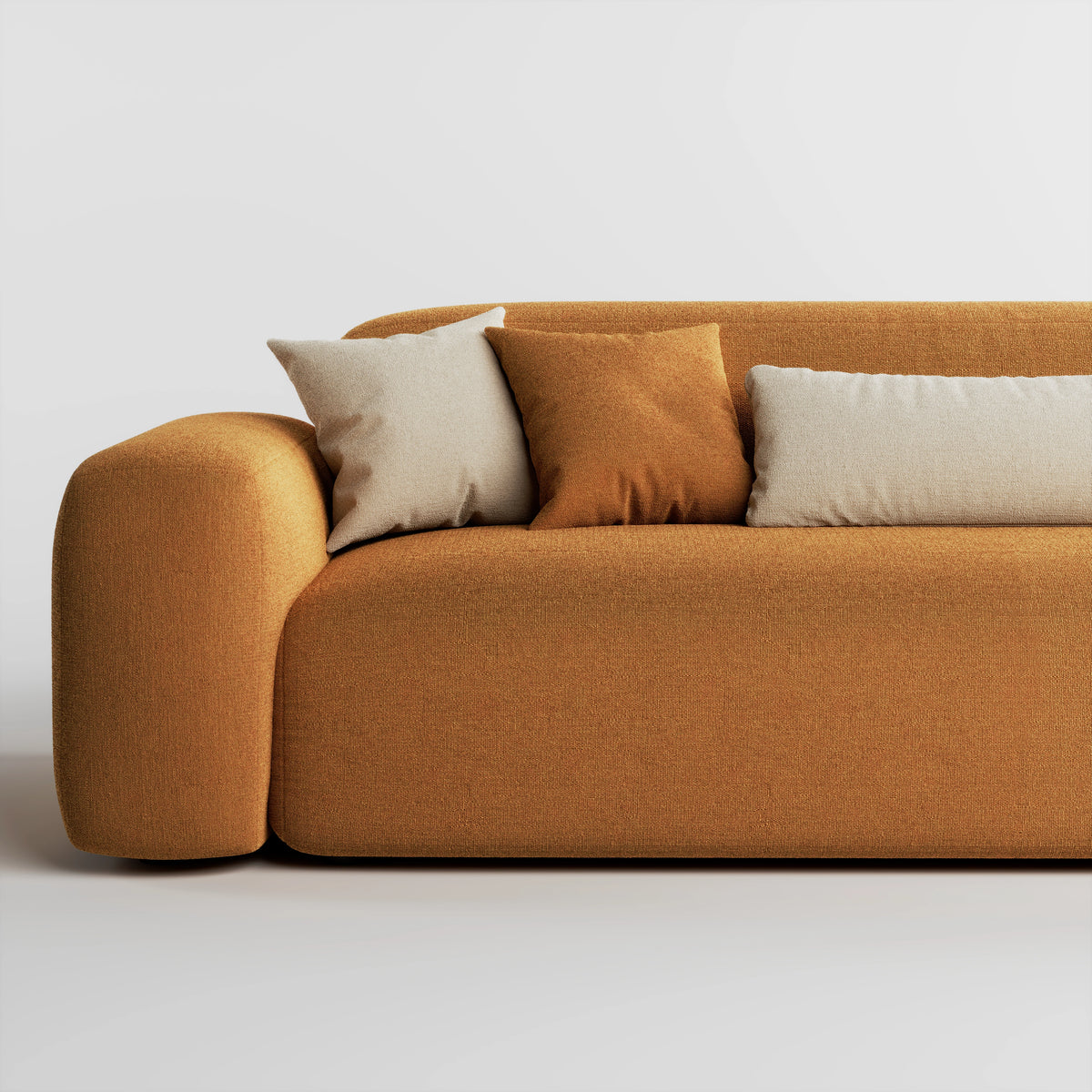 Close up of Cove 3 seater sofa in amber fabric showing armrest, seat, and cushions